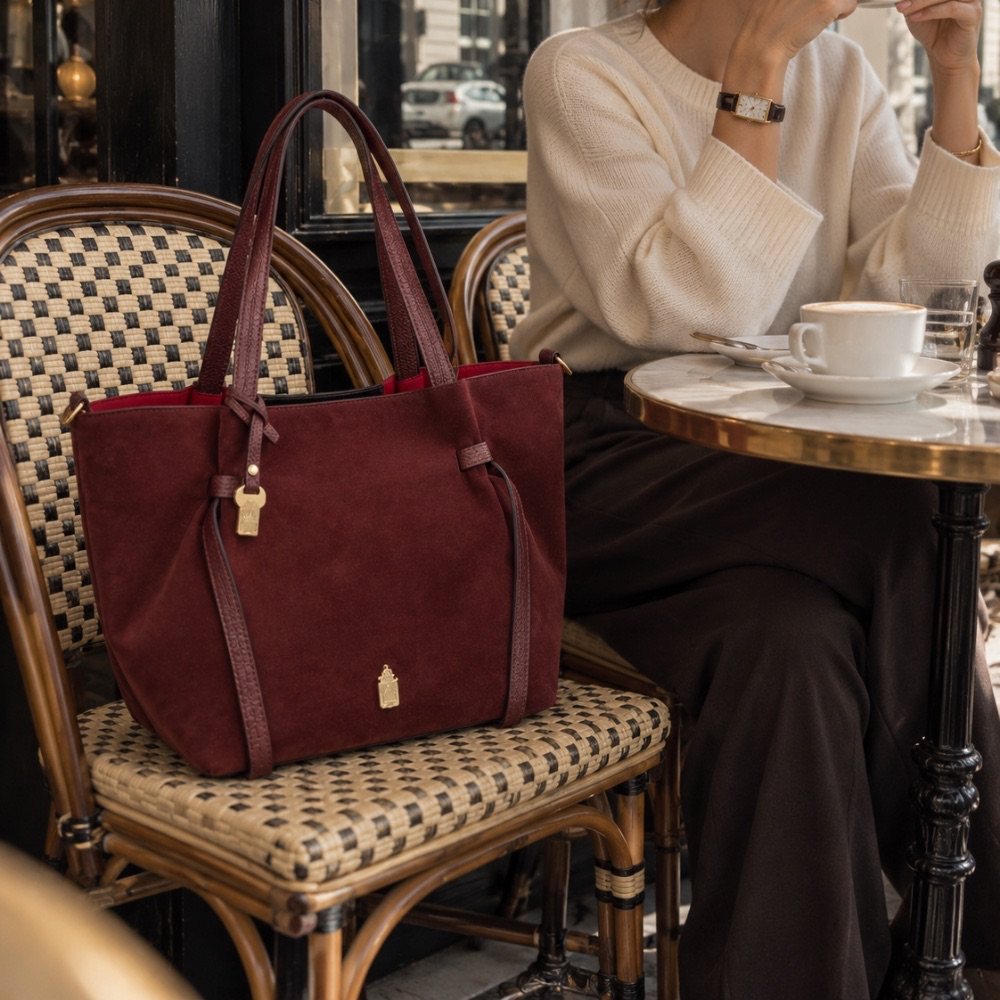 Simona in Beautiful Burgundy on a café chair